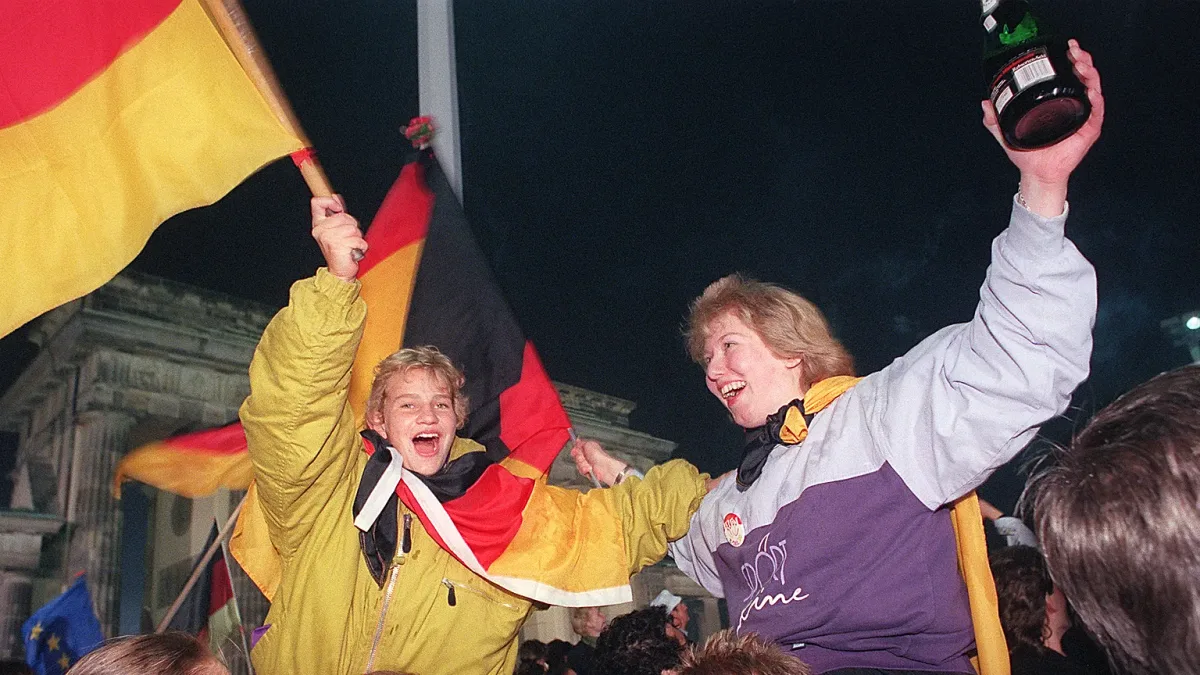 Germans celebrate reunification at Berlin’s Brandenburg Gate, October 3, 1990 (Gilles Leimdorger/AFP)