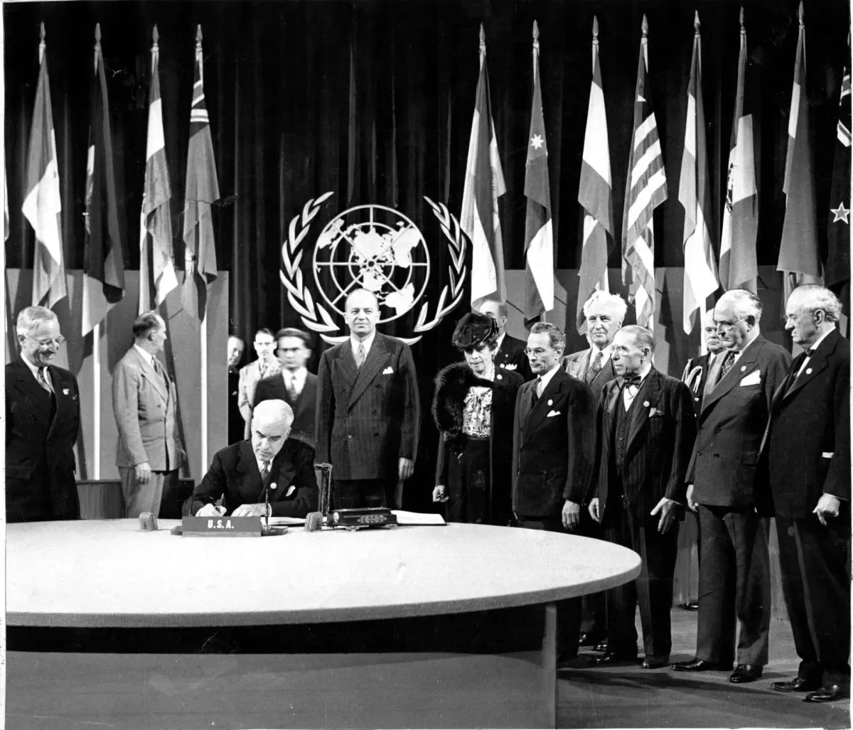 President Harry S. Truman watches as Secretary of State Edward Stettinius signs the UN Charter at the San Francisco Conference, June 26, 1945. (Associated Press)
