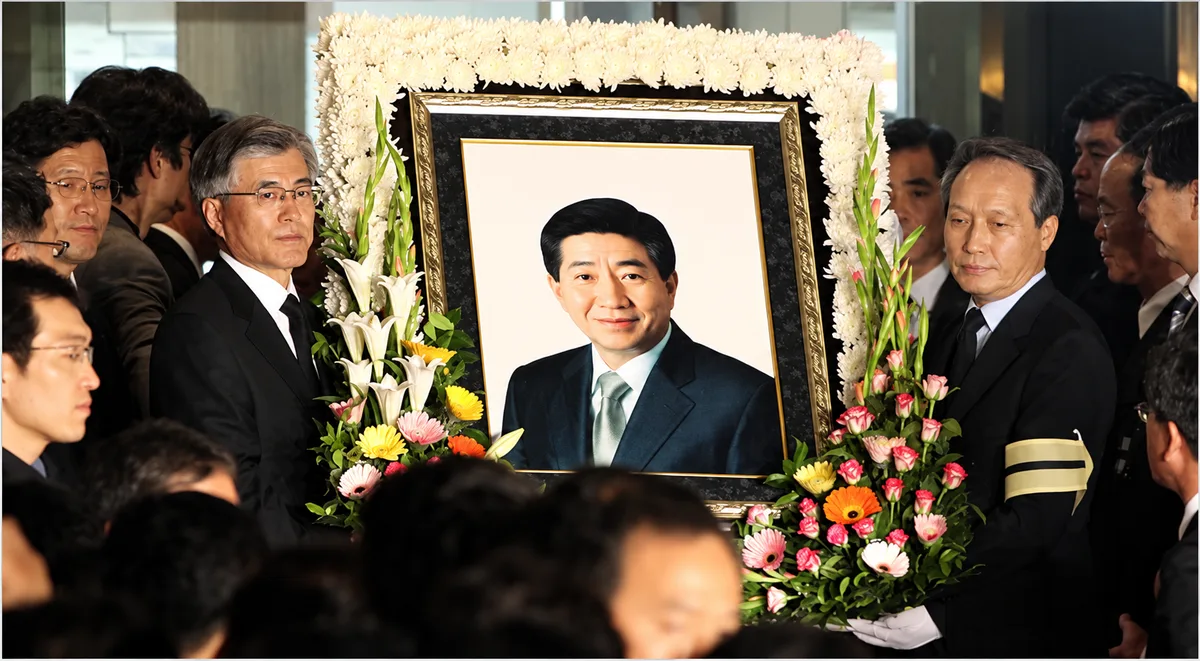 A portrait of former President Roh Moo-hyun of South Korea was carried into a funeral home in Kimhae by some of his former aides on Saturday. Mr. Roh committed suicide early Saturday. (Ahn Young-joon/Associated Press)