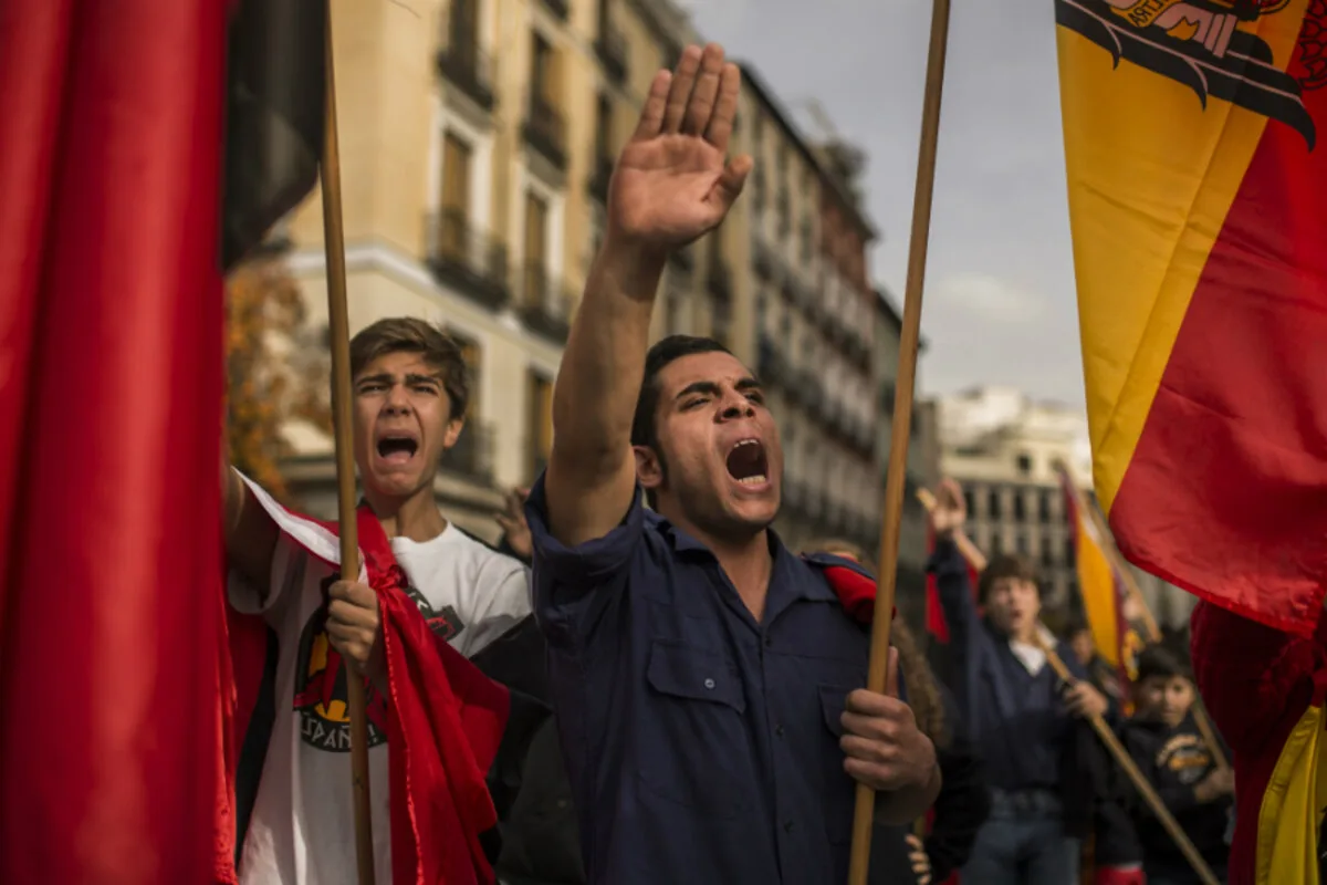 Far-right supporters raise their right arms in salute as they commemorate former Spanish dictator Francisco Franco on the 39th anniversary of his death in Madrid