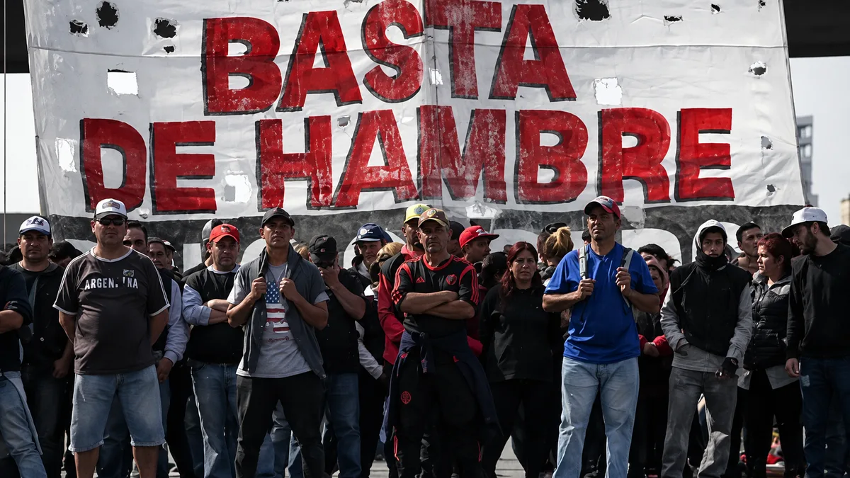 Demonstrators in Argentina march beneath a banner reading “Basta de hambre” (“Enough hunger”) in 2019 (Getty Images).