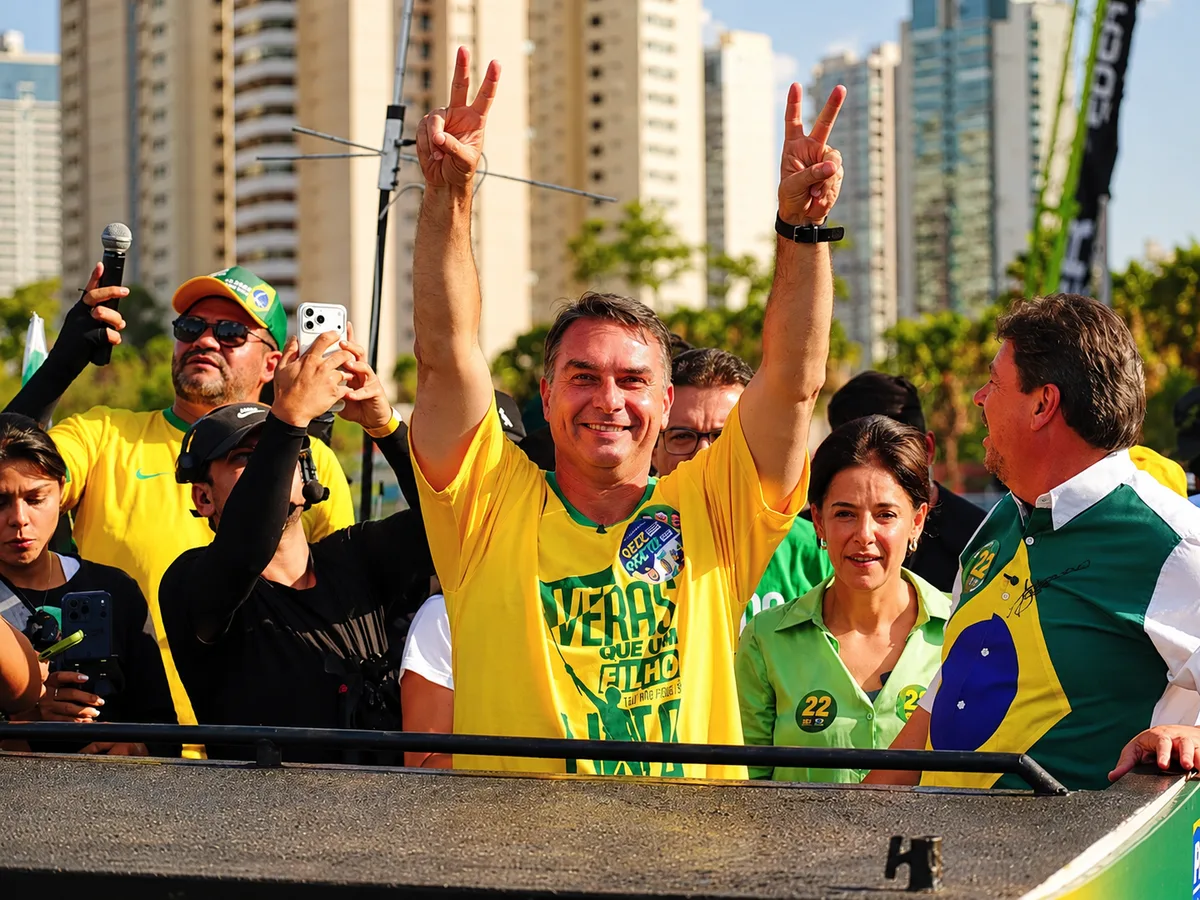 Flávio Bolsonaro surrounded by supporters during an election campaign rally in Brazil (Democrata).