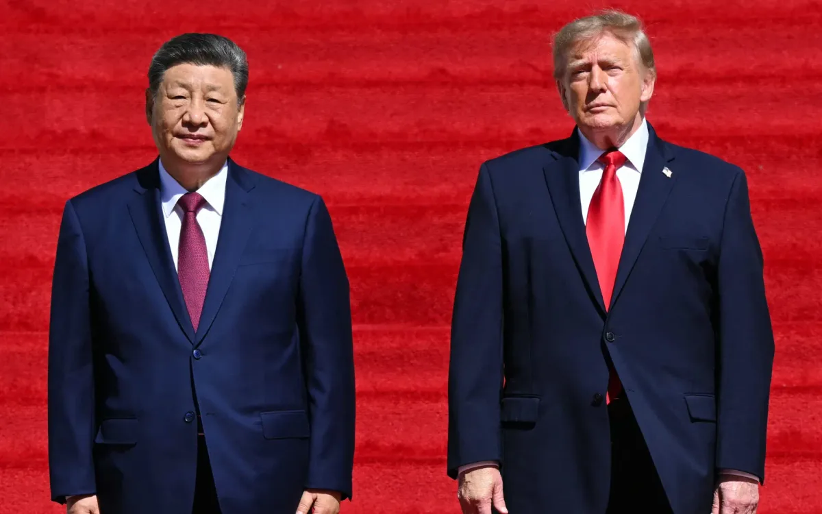 US President Donald Trump stands with China's President Xi Jinping as they arrive to visit the National Archives in Washington, DC. (SAUL LOEB/AFP)