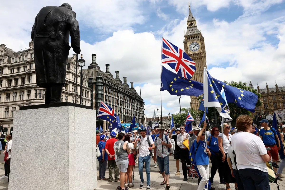 Marchers pass Big Ben, in London on 20 June 2026 during the fourth National Rejoin March, held to mark ten years since the Brexit referendum and to call for closer UK-EU cooperation. (Macaskill 2026)